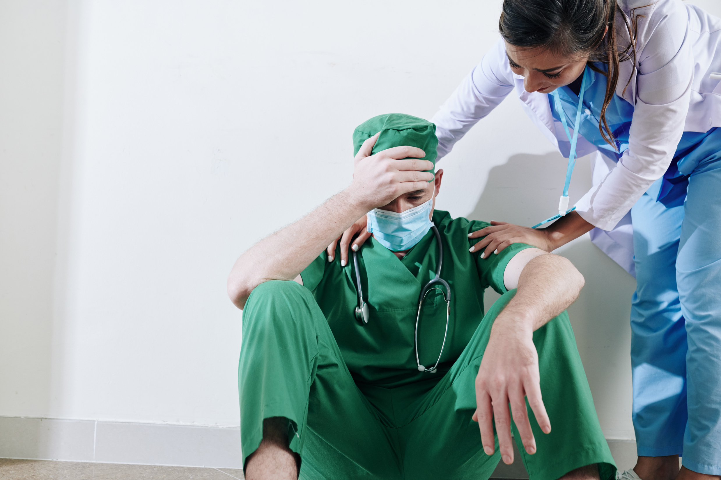 Nurse Reassuring Stressed Surgeon